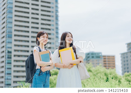 Two female university students walking on campus Two female university students walking on campus 141215410