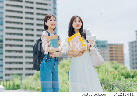 Two female university students walking on campus Two female university students walking on campus 141215411