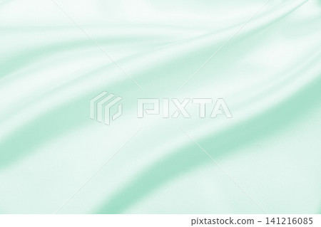 Smooth elegant green silk or satin luxury cloth texture as abstract background. Luxurious background design 141216085