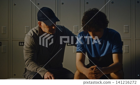 Teen Athlete Receiving Advice from Coach After Sports Defeat Teen Athlete Receiving Advice from Coach After Sports Defeat 141216272