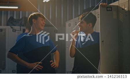 Young Soccer Teammates Laughing at Smartphone Videos Before Match Young Soccer Teammates Laughing at Smartphone Videos Before Match 141216313