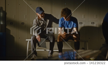 Youth Football Team Locker Room with Coach and Disappointed Player Youth Football Team Locker Room with Coach and Disappointed Player 141216322