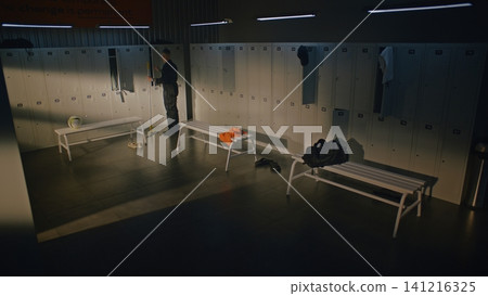 Male Janitor Mopping Floor and Cleaning Empty Sports Locker Room Male Janitor Mopping Floor and Cleaning Empty Sports Locker Room 141216325