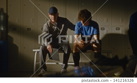 Youth Football Team Locker Room with Coach and Disappointed Player Youth Football Team Locker Room with Coach and Disappointed Player 141216326
