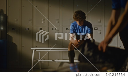 Youth Football Team Locker Room with Coach and Disappointed Player Youth Football Team Locker Room with Coach and Disappointed Player 141216334