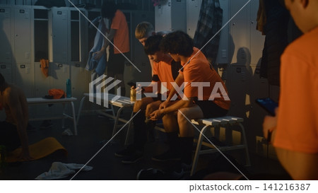 Teenage Football Players Sit Together in Warm Locker Room Teenage Football Players Sit Together in Warm Locker Room 141216387