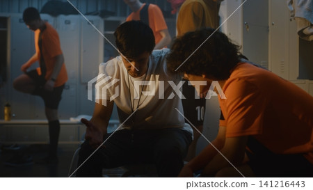 Football Coach Takes Moment to Motivate One of Teenage Players in Locker Room Football Coach Takes Moment to Motivate One of Teenage Players in Locker Room 141216443