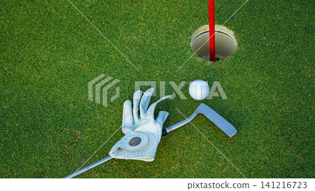 Golf balls on a green lawn in a beautiful golf course with morning sunshine. Golf balls on a green lawn in a beautiful golf course with morning sunshine. 141216723