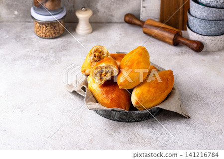 Traditional baked pies pirozhki with meat. Traditional baked pies pirozhki with meat. 141216784
