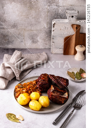 Grilled ribs with sauerkraut and potatoes Grilled ribs with sauerkraut and potatoes 141216785