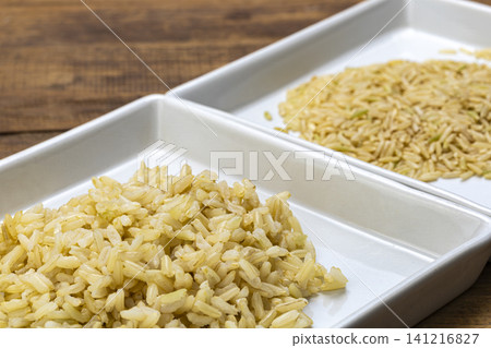 Close-Up Comparison of Cooked and Raw Brown Jasmine Rice Portions Arranged Side by Side in a Divided White Ceramic Tray on Rustic Wooden Surface Close-Up Comparison of Cooked and Raw Brown Jasmine Rice Portions Arranged Side by Side in a Divided White Ceramic Tray on Rustic Wooden Surface 141216827