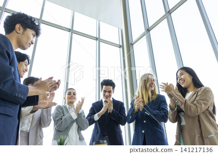 Happy multiracial business team giving high fives gesture, celebrating success. Achievement mission at company. Happy multiracial business team giving high fives gesture, celebrating success. Achievement mission at company. 141217136