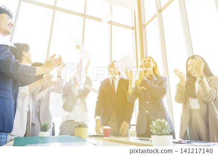 Happy multiracial business team giving high fives gesture, celebrating success. Achievement mission at company. Happy multiracial business team giving high fives gesture, celebrating success. Achievement mission at company. 141217140