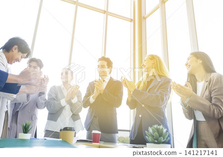Happy multiracial business team giving high fives gesture, celebrating success. Achievement mission at company. Happy multiracial business team giving high fives gesture, celebrating success. Achievement mission at company. 141217141