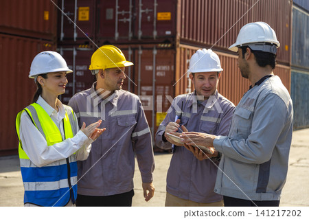 Group of engineers working and inspecting freight order in the container yard. This is a freight transportation and distribution warehouse. Group of engineers working and inspecting freight order in the container yard. This is a freight transportation and distribution warehouse. 141217202