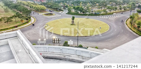 Traffic roundabout with a central garden in a residential area Traffic roundabout with a central garden in a residential area 141217244