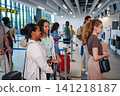 Diverse travelers waiting in line at airport check-in 141218187
