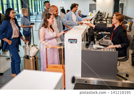 Passengers checking in a flight at airport during a trip Passengers checking in a flight at airport during a trip 141218195