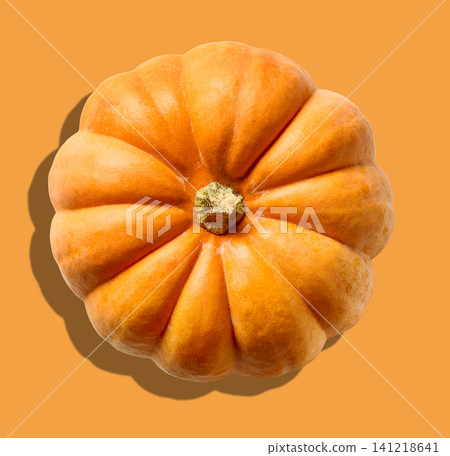 Single Pumpkin on Orange Background, Top View, Halloween Minimal Concept Single Pumpkin on Orange Background, Top View, Halloween Minimal Concept 141218641
