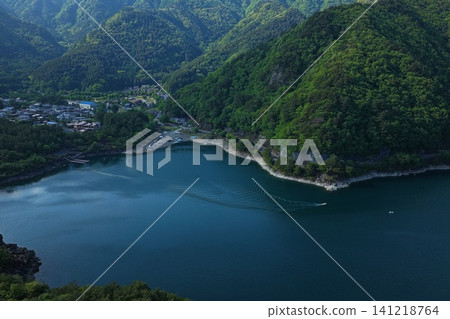 An aerial photograph overlooking Lake Saiko and the surrounding green mountains in Yamanashi Prefecture. An aerial photograph overlooking Lake Saiko and the surrounding green mountains in Yamanashi Prefecture. 141218764