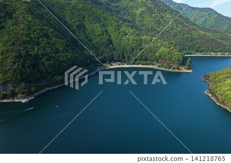 A spring aerial photograph capturing Lake Saiko in Yamanashi Prefecture and the lush green mountains. A spring aerial photograph capturing Lake Saiko in Yamanashi Prefecture and the lush green mountains. 141218765