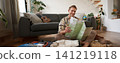 Portrait of handsome young man, traveller with suitcase, looking at paper map, choosing where to go on vacation, going on holiday, choosing route 141219118