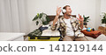 Portrait of handsome young man in wireless headphones, dancing and singing in wireless headphones, tourist getting ready for holiday, packing suitcase for business trip 141219144