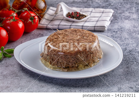 Meat pate on white plate with fresh tomatoes and peppercorns 141219211