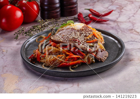 Beef and glass noodle stir fry with sesame seeds and red peppers 141219223