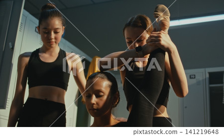 Group of Teen Practicing Difficult Contortion Stretch Backstage Group of Teen Practicing Difficult Contortion Stretch Backstage 141219648
