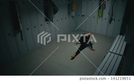 Young Female Athlete Practicing Floor Gymnastics Sequence in Changing Room Young Female Athlete Practicing Floor Gymnastics Sequence in Changing Room 141219651