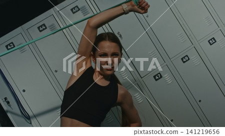 Exhausted Teen Pushes in Pain to Exercise Side Obliques and Arms With Fitness Band Exhausted Teen Pushes in Pain to Exercise Side Obliques and Arms With Fitness Band 141219656