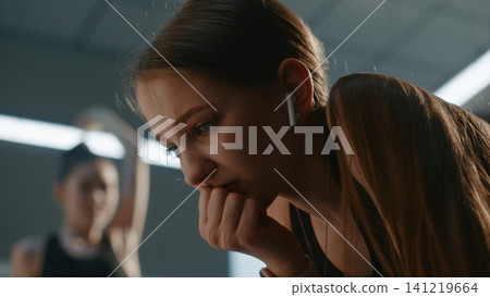 Upset Teenage Girl Listening to music to Calm Down inside Changing Room Upset Teenage Girl Listening to music to Calm Down inside Changing Room 141219664