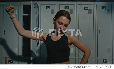 Exhausted Teen Pushes in Pain to Exercise Side Obliques and Arms With Fitness Band Exhausted Teen Pushes in Pain to Exercise Side Obliques and Arms With Fitness Band 141219671