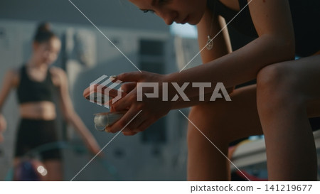 Gymnast Holding Smartphone and Wireless Earphones Case 141219677