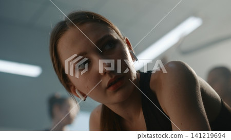 Angry and Exhausted Teen Gymnast Breathing Heavily After Hard Training 141219694