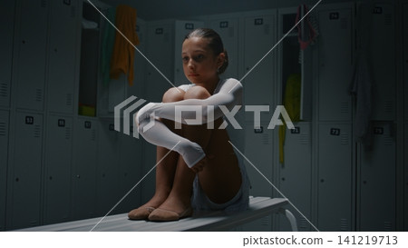 Depressed Teen Gymnast Sitting Alone in Empty Locker Room after Championship Loss Depressed Teen Gymnast Sitting Alone in Empty Locker Room after Championship Loss 141219713
