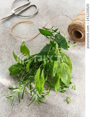 Fresh garden herbs with scissors and twine for cooking Fresh garden herbs with scissors and twine for cooking 141220020
