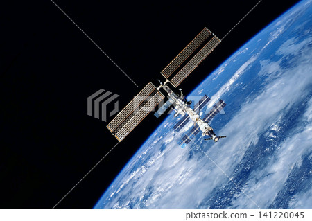 International Space Station floats above Earth's blue oceans and white clouds. Elements of this image furnished by NASA International Space Station floats above Earth's blue oceans and white clouds. Elements of this image furnished by NASA 141220045