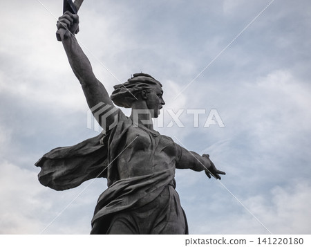 Volgograd, Russia - 05.23.2023: Low angle view of The Motherland Calls statue on Mamayev Kurgan in Volgograd, Russia. One of the tallest statues in the world, symbolizing the Soviet victory in World W Volgograd, Russia - 05.23.2023: Low angle view of The Motherland Calls statue on Mamayev Kurgan in Volgograd, Russia. One of the tallest statues in the world, symbolizing the Soviet victory in World W 141220180