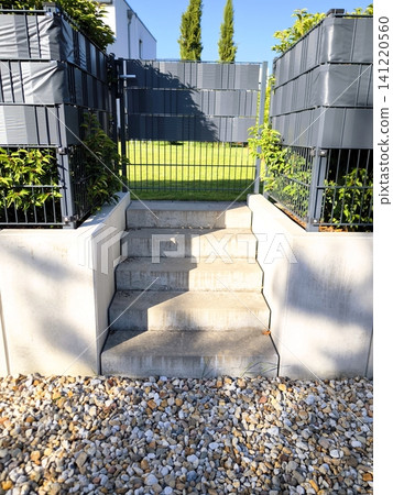 Concrete steps and a modern garden gate Concrete steps and a modern garden gate 141220560