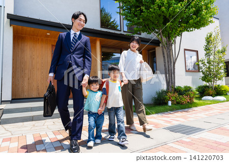 A family of four leaves home with smiles on their faces (father commuting to work and children going to daycare/school). A family of four leaves home with smiles on their faces (father commuting to work and children going to daycare/school). 141220703