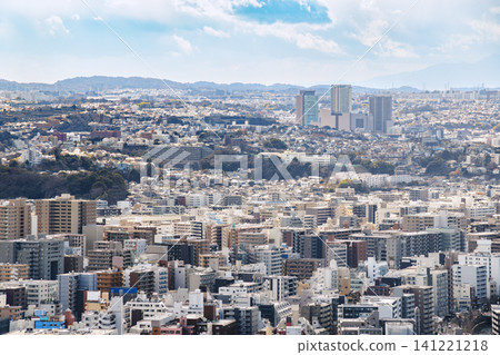 A landscape of densely packed city buildings and rolling hills stretching out in the distance. A landscape of densely packed city buildings and rolling hills stretching out in the distance. 141221218
