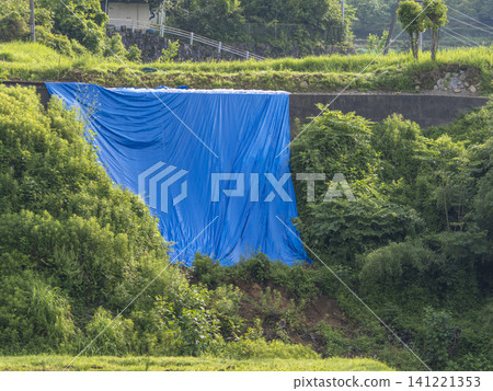 Road with retaining wall collapsed due to heavy rain. Road with retaining wall collapsed due to heavy rain. 141221353