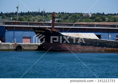 Old Rusty Cargo Ship Moored at the Harbor. Old Rusty Cargo Ship Moored at the Harbor. 141221733
