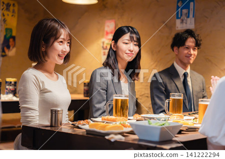 Young working adults drinking at an izakaya (Japanese pub) Young working adults drinking at an izakaya (Japanese pub) 141222294