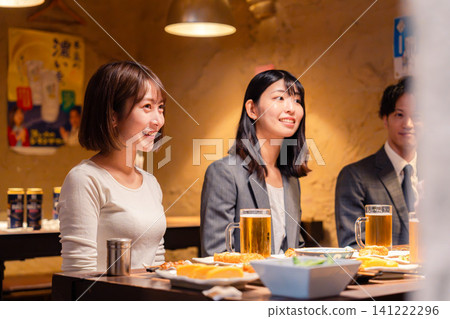 Young working adults drinking at an izakaya (Japanese pub) Young working adults drinking at an izakaya (Japanese pub) 141222296