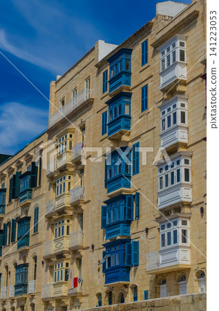 Traditional Maltese enclosed wooden balconies in Valletta Malta, colorful gallarija on limestone facade against blue sky, architecture. High quality photo Traditional Maltese enclosed wooden balconies in Valletta Malta, colorful gallarija on limestone facade against blue sky, architecture. High quality photo 141223053