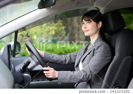 Asian businessman driving a car Asian businessman driving a car 141223102