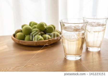 Harvested green plums and plum juice Harvested green plums and plum juice 141223151